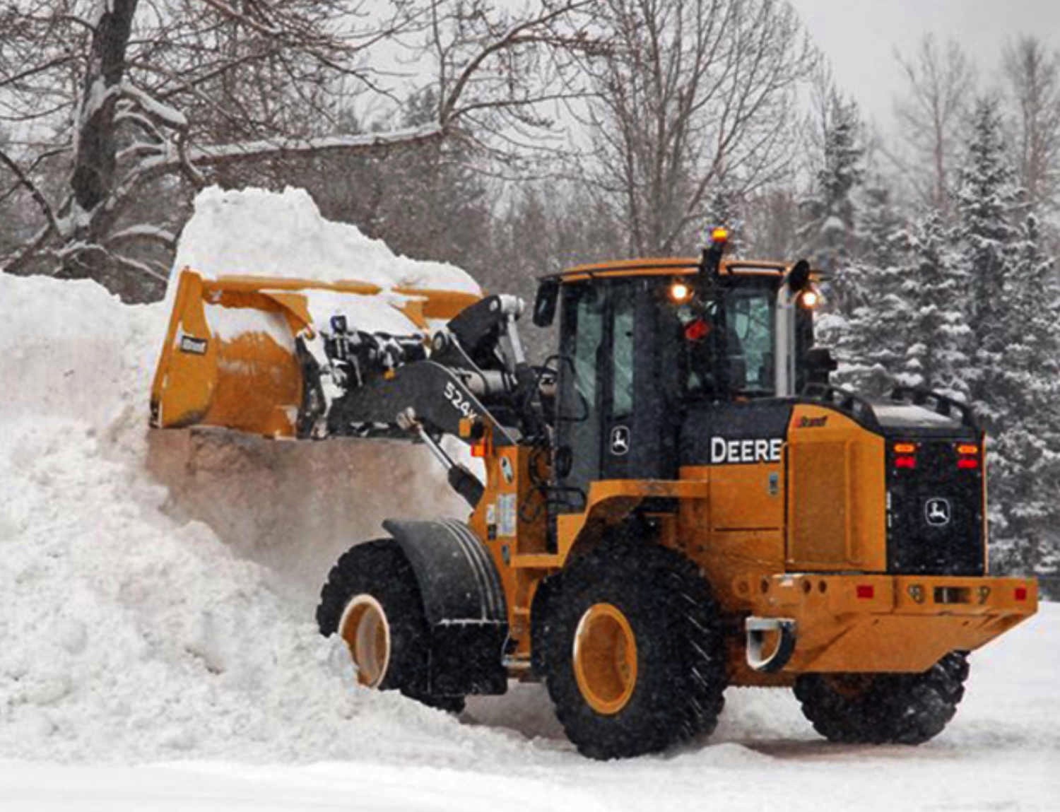 A picture of our payloader performing Snow Removal.