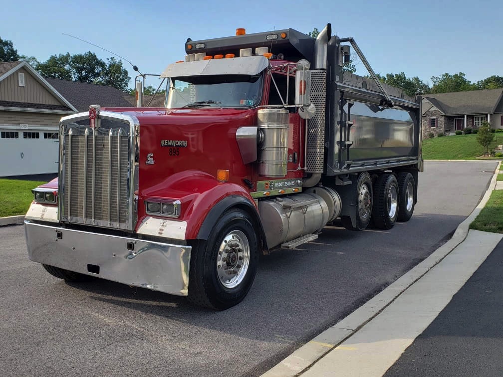 A picture of an American Truck hauling gravel.